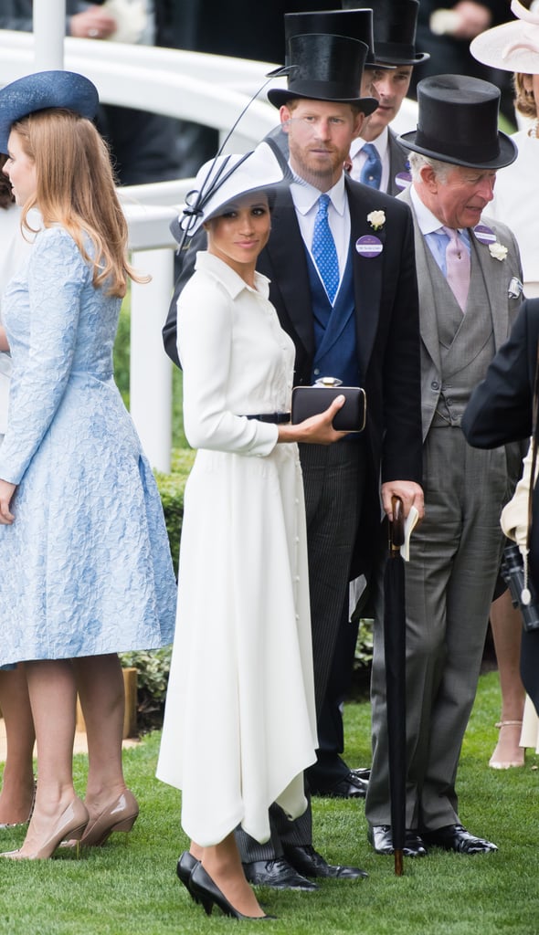 At the 2018 Royal Ascot, Meghan wore a white Givenchy shirtdress. To accessorize her stunning outfit, Meghan opted for a black clutch, matching heels, and a black and white hat by Philip Treacy.
