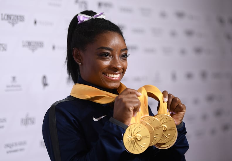 STUTTGART, GERMANY - OCTOBER 13: Simone Biles of USA poses with her Medal haul after the Apparatus Finals on Day 10 of the FIG Artistic Gymnastics World Championships at Hanns Martin Schleyer Hall  on October 13, 2019 in Stuttgart, Germany. (Photo by Laur