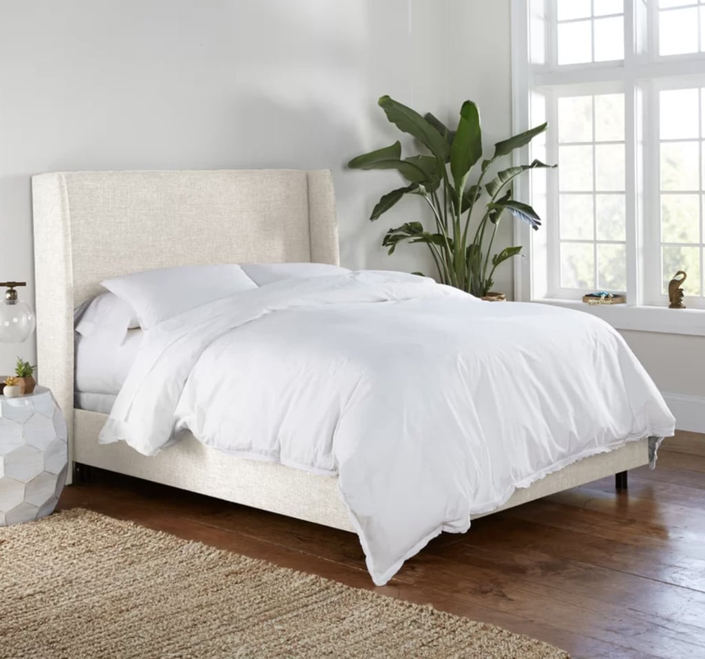 Joss & Main Tilly Upholstered Bed ($849, originally $899)
If you're looking to add volume to your bedroom like Shaffer recommends, we adore the large, wingback headboard on this Joss & Main Tilly Upholstered Bed. The bed frame is covered in foam padding to ensure you have a comfortable night's rest. With over 7,000 five-star reviews, this frame is slated to be a winner. 
What we love:
It comes in so many fun color choices and fabric options, 53 to be exact.
Its wingback design will make your bedroom appear taller.
Who it's best for:
This is best for those who want a luxurious look and feel in their space.
Who should avoid it:
A box spring is required for this bed frame, so if you do not already have one, you will need to purchase one for this bed frame.
The Details: Material: Linen, boucle, velvet, and performance fabric | Sizes: Twin, full, queen, king, California king | Color Options: 47