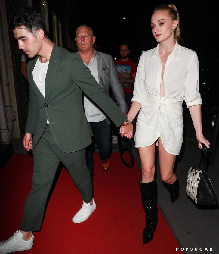 Sophie Turner in White Dress and Black Boots in Paris