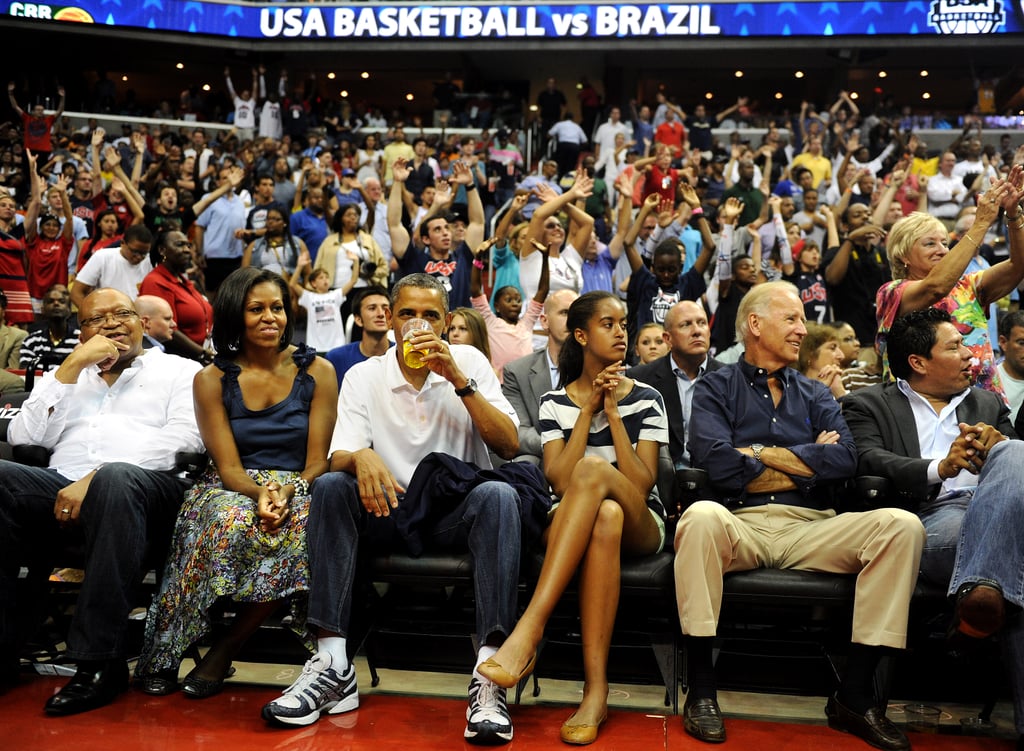 The president drank a beer while enjoying a game with his family and Vice President Joe Biden.