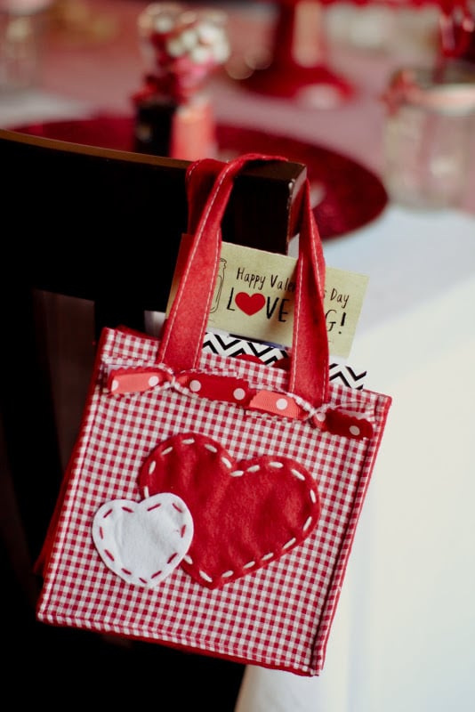 Guests took home cute, small, red-and-white heart bags as party gifts. 
Source: Jenny Cookies