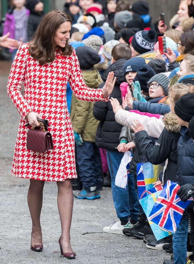 The Duchess of Cambridge greeted the crowd on Jan. in a bright Catherine Walker houndstooth coat. She accessorized with a pair of fringed heels from Tod's, a Chanel bag, and a pair of pearl earrings by the Swedish brand In2Design.