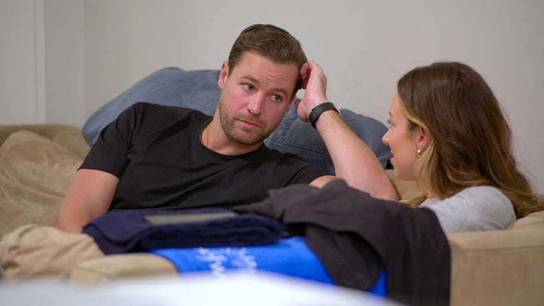 A photo of Love Is Blind Season 8 contestants Dave and Lauren sit on a couch and talk.