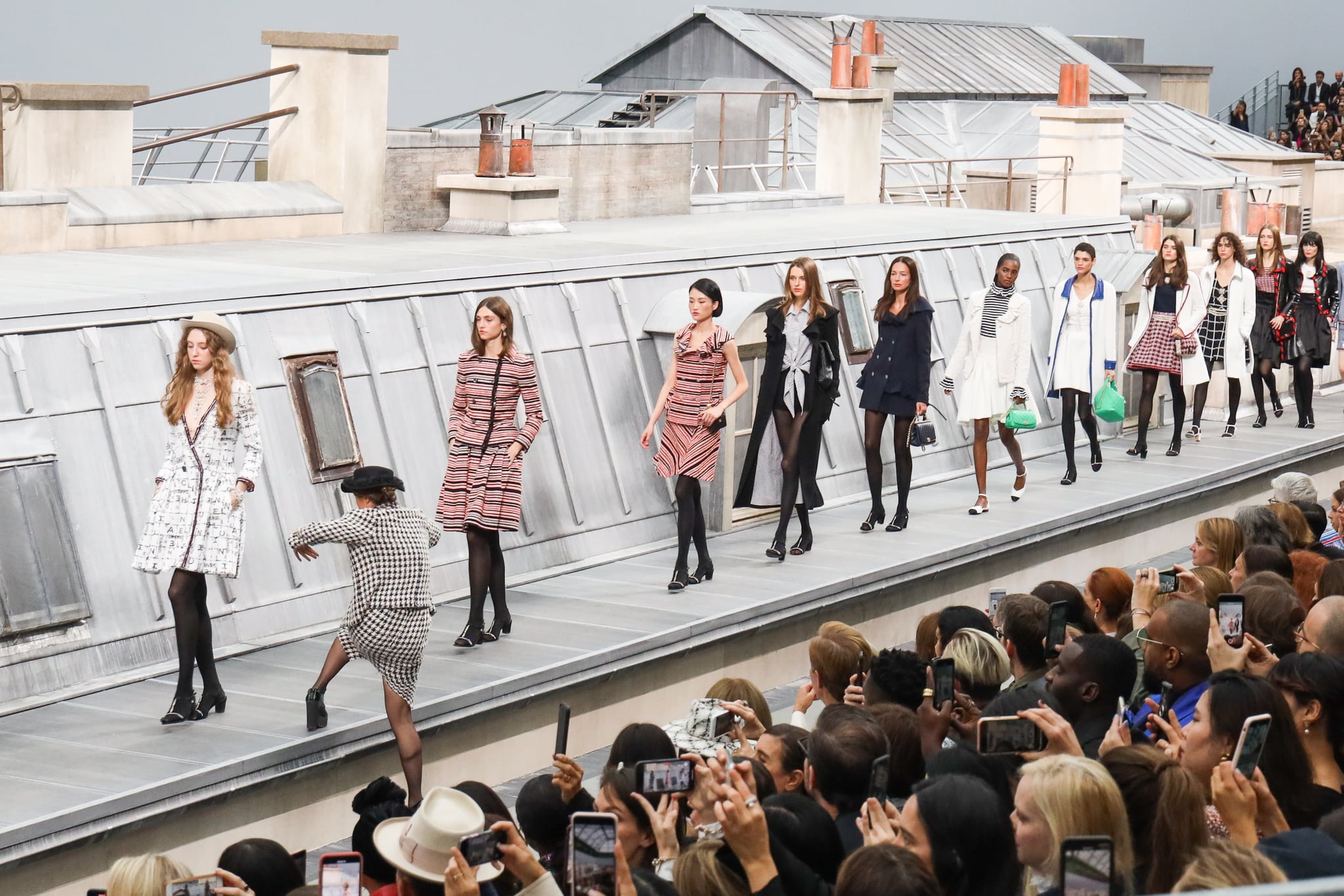 PARIS, FRANCE - OCTOBER 01: A spectator from the audience climbs the runway to walk with the models during the finale of the Chanel Womenswear Spring/Summer 2020 show as part of Paris Fashion Week on October 1, 2019 in Paris, France. (Photo by Victor Boyko/Getty Images)