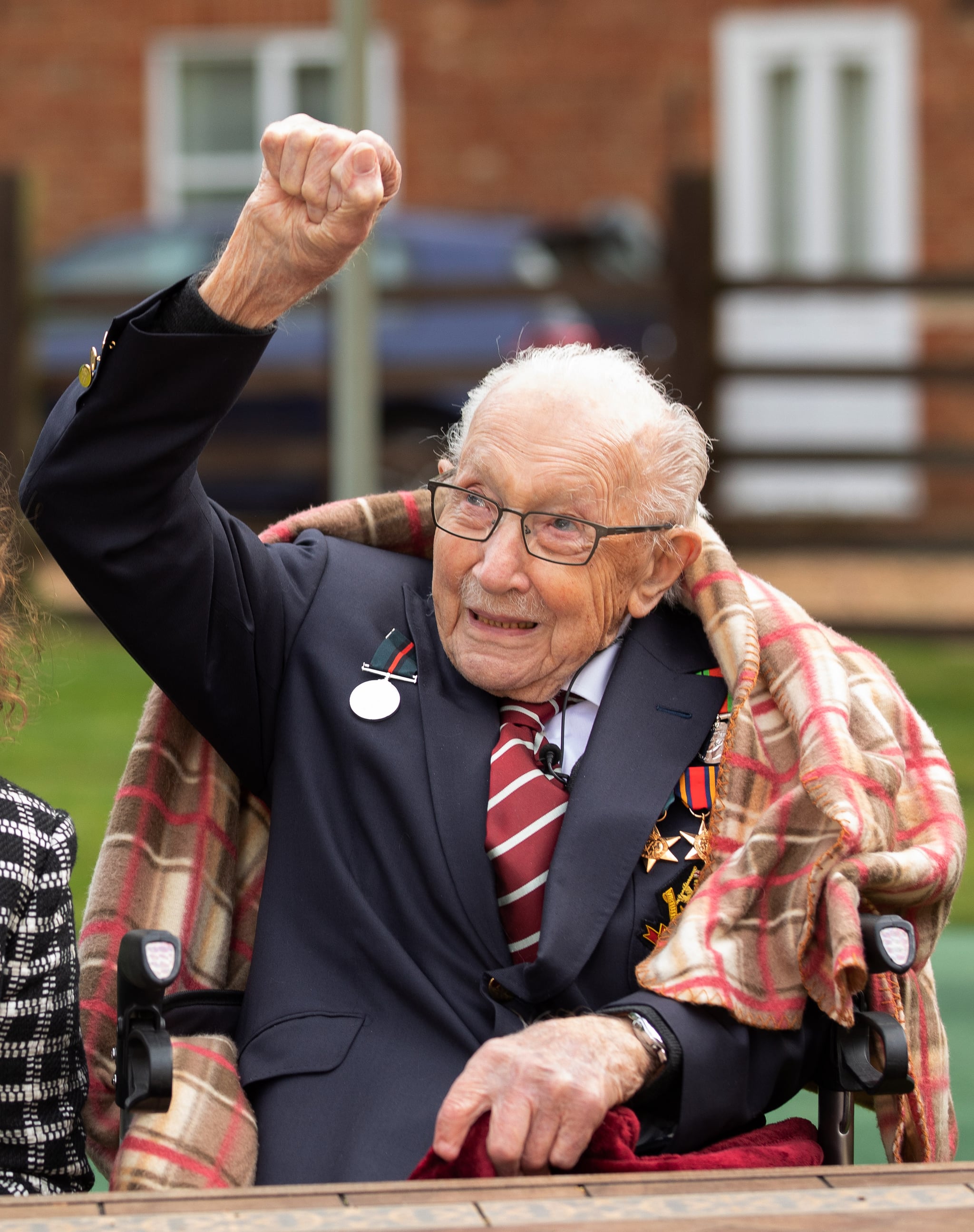 MARSTON MORETAINE, ENGLAND - In this handout image provided by Capture the Light Photography, Colonel Tom Moore and his daughter Hannah celebrate his 100th birthday, with an RAF flypast provided by a Spitfire and a Hurricane over his home on April 30, 2020 in Marston Moretaine, England. Colonel Moore, formerly a Captain, received a promotion in honour of his 100th birthday and in recognition of the funds, in excess of £29m, he raised for the NHS by walking laps of his garden. (Emma Sohl - Capture the Light Photography via Getty Images)