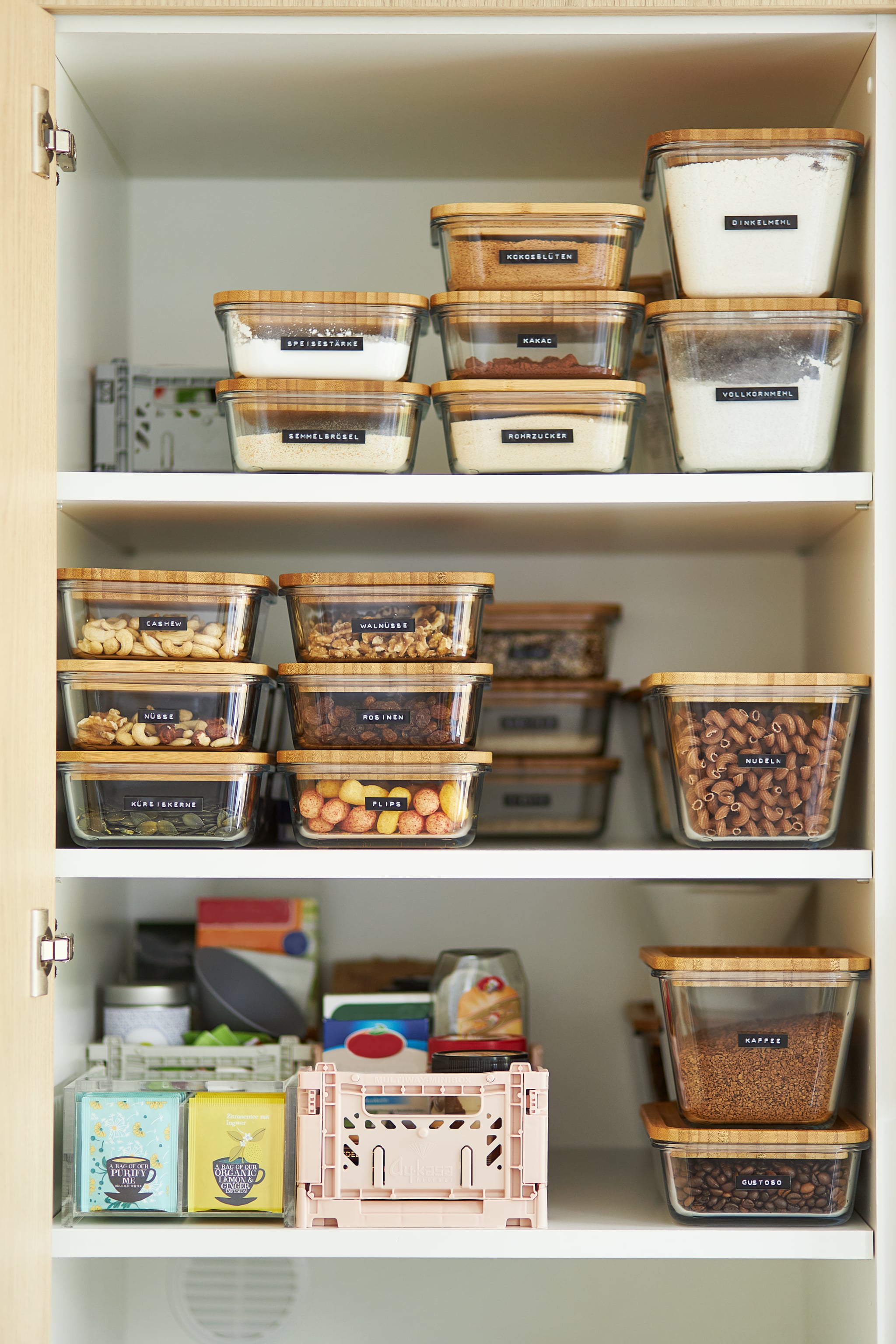 A middle-aged woman tidies up her cupboard in the kitchen and reorganizes everything to make a comparison before and after