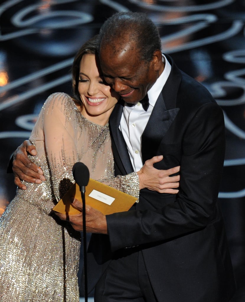 Angelina Jolie cuddled up to Sidney Poitier on stage as they presented the award for best director.