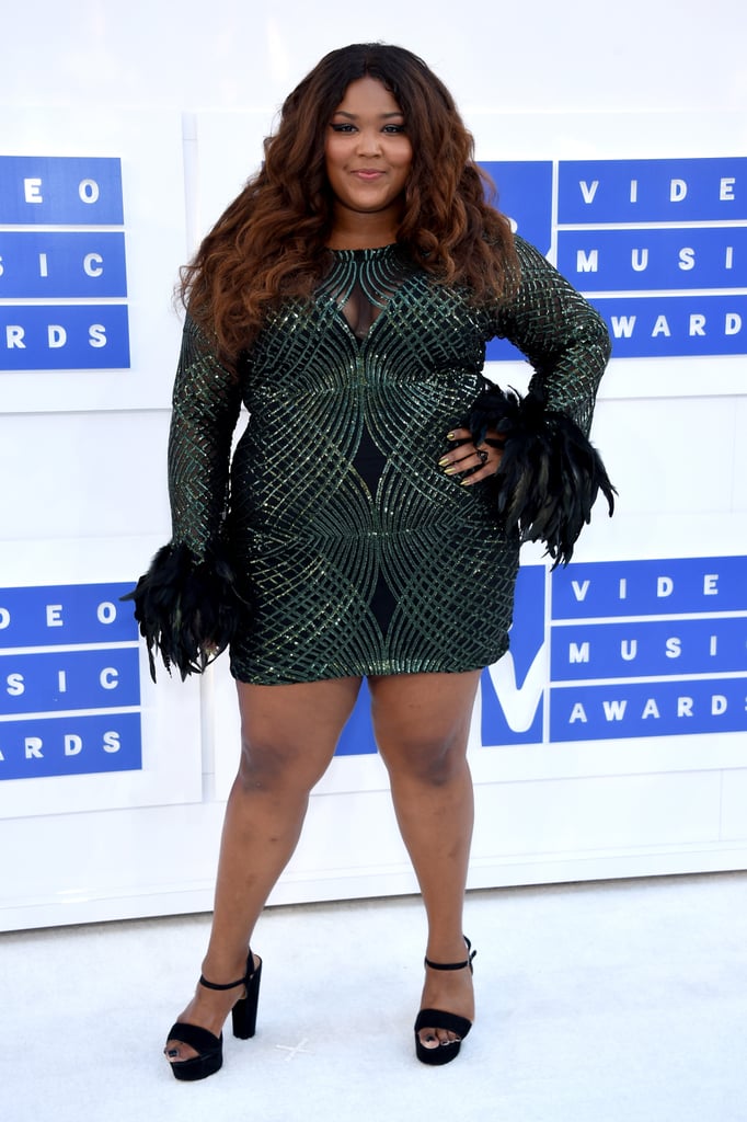 Even when she's not performing, Lizzo steals the show in outfits like this shimmery green dress with eye-catching feathered sleeves, which she wore to the 2016 MTV VMAs.