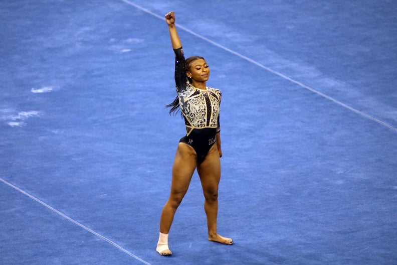 LOS ANGELES, CALIFORNIA - FEBRUARY 27: Nia Dennis of the UCLA Bruins raises a fist during her floor routine during a meet against the Oregon State Beavers at Pauley Pavilion on February 27, 2021 in Los Angeles, California. (Photo by Katharine Lotze/Getty 