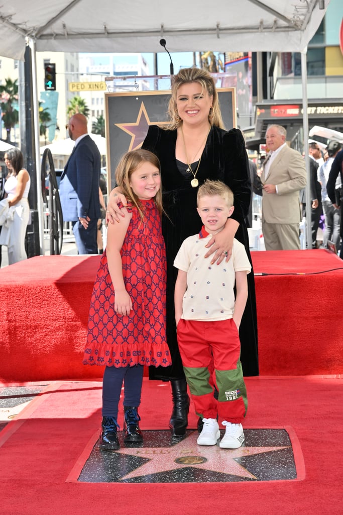 Kelly Clarkson was joined by her two kids, River, 8, and Remington Blackstock, 6, at her Hollywood Walk of Fame ceremony on Monday, Sept. 19. The 40-year-old three-time Grammy winner was honored with the 2,733rd star for her recording accomplishments.
"Kelly Clarkson has been long deserving of a spot on the Hollywood Walk of Fame," stated Ana Martinez, producer of the Hollywood Walk of Fame, in a press release. "She has been an iconic person in American pop culture since she walked onto the first audition stage on 'American Idol' and has continued to impress fans with her musical and talk show prowess."
In addition to Clarkson's kids being in attendance, the event also reunited her with "American Idol" judges Randy Jackson, Paula Abdul, and Simon Cowell, who was one of the guest speakers, along with producer Jason Halbert. "We were just talking about the moment when you sang 'Respect,' and we all looked at each other, and it was like, 'Oh. My. God. Thank you.' And then, I went up to you, afterwards, because obviously, I was thinking, 'I think you're gonna win this show,' and I said, 'I just wanna say, that was amazing, Kelly, and I'm here,' and you turned around to me and said, 'Simon, without being rude, I would rather we didn't talk until the end of the series,' and I'm like, 'Wow, what does that mean?' It means, stay away from me, I know what I'm doing,'" Cowell recalled in his speech. "I always say if someone knows their lane, you're gonna be a star, if you got the talent. And Kelly has always known her lane."
When it was Clarkson's turn to speak, she made sure to thank the judges for their support and reflected on her career over the past 20 years. "From the beginning, with 'Idol,' all three of you were very honest with me . . . I just wanted to say thank you . . .  I think it's important to have not just 'yes' people, but people that actually love you, and care about you and give their honest advice, and I've always welcomed that," Clarkson said. "And I think that is why I'm here today. Not just because of myself, but because of having constantly teams of people that love you and support you, and really want to make your dreams come true while making their dreams come true."
See photos from Clarkson's Hollywood Walk of Fame ceremony ahead.

    Related:

            
            
                                    
                            

            Kelly Clarkson Felt Pressured to Be Sexual as a Rising Pop Star: "I Had to Fight Like Hell"