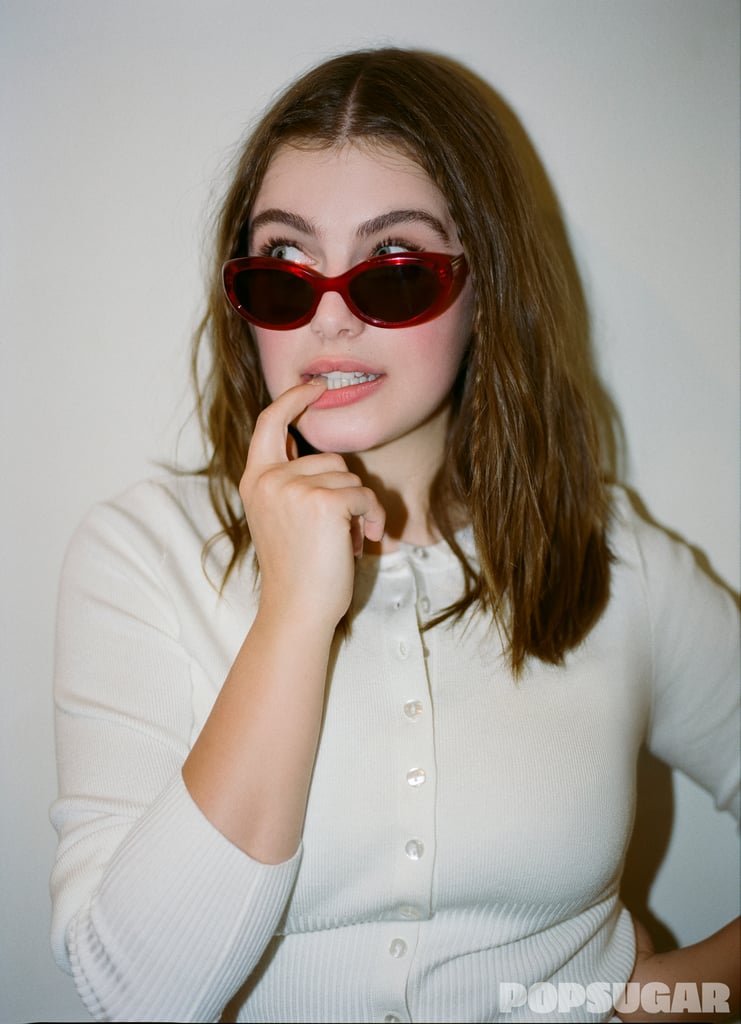 525 America Anne High Waist Rib cardigan ($89). Oliver Peoples x Khaite 1969C sunglasses ($524).
It's no secret that red evokes passion and intrigue — the perfect color for the summer of yearning. You can embrace the fiery hue with a little red dress or a pair of clear sunglasses like Bright: the options are endless.
Get The Look: H&M Fine Knit Cardigan ($30). Freyrs Eyewear Aria Oval Sunglasses ($85).