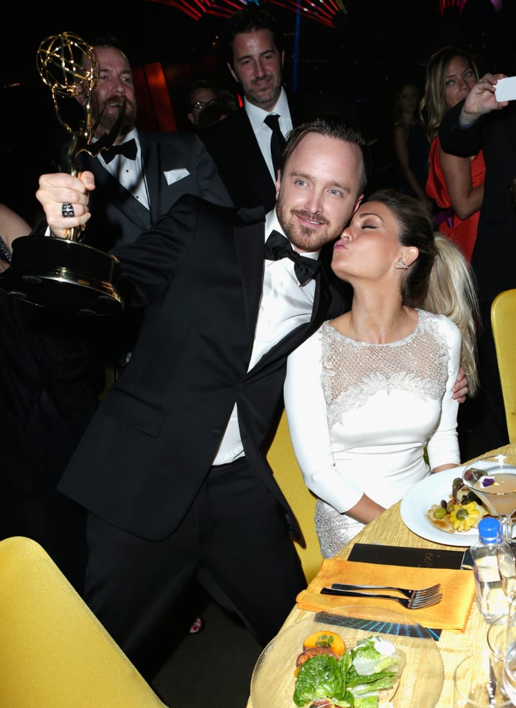 Aaron Paul got a sweet smooch from his wife, Lauren Parsekian, during the Governors Ball.
