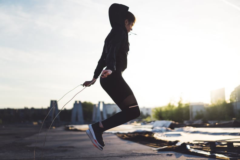 Young woman exercising, working out in the urban jungle, outdoors workout, focusing on her goals, setting high goals