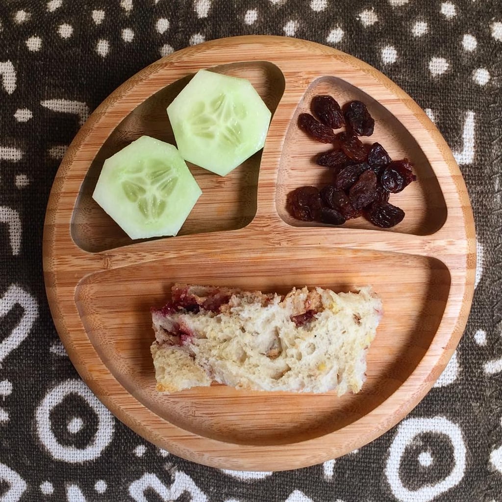 "Lunch: PB&J on sourdough bread, raisins, and cucumber."