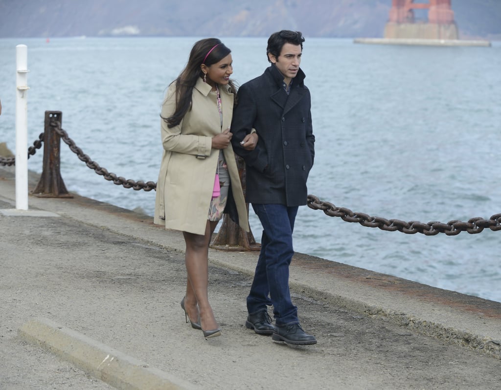 Mindy and Danny walk arm in arm along the bay.