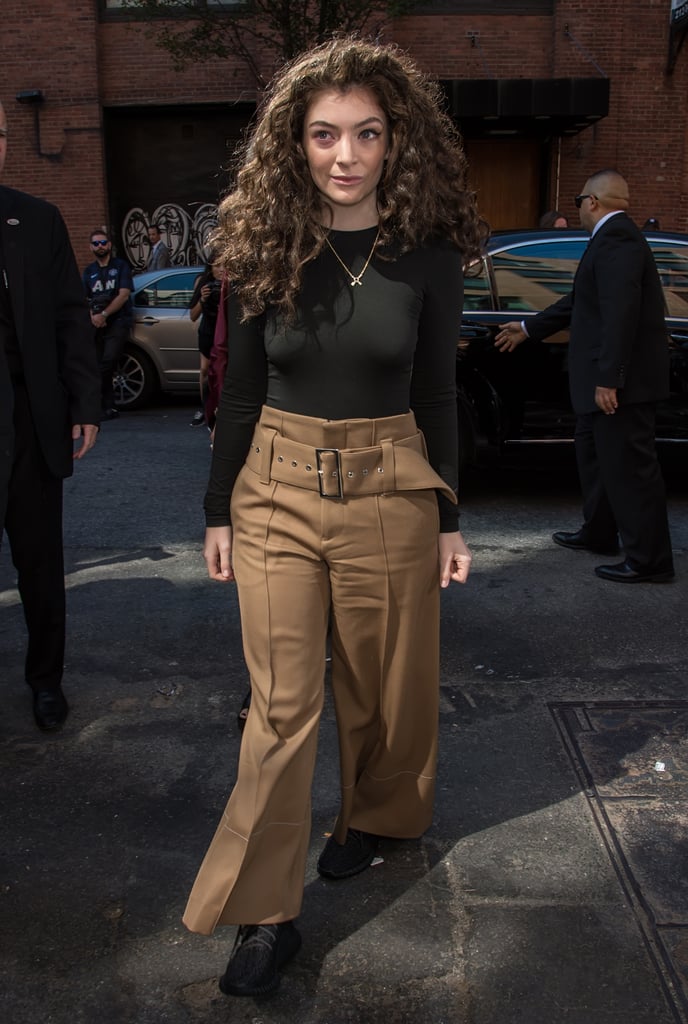 Lorde rolled up in a black long-sleeved shirt that she tucked into pleated wide-leg trousers.