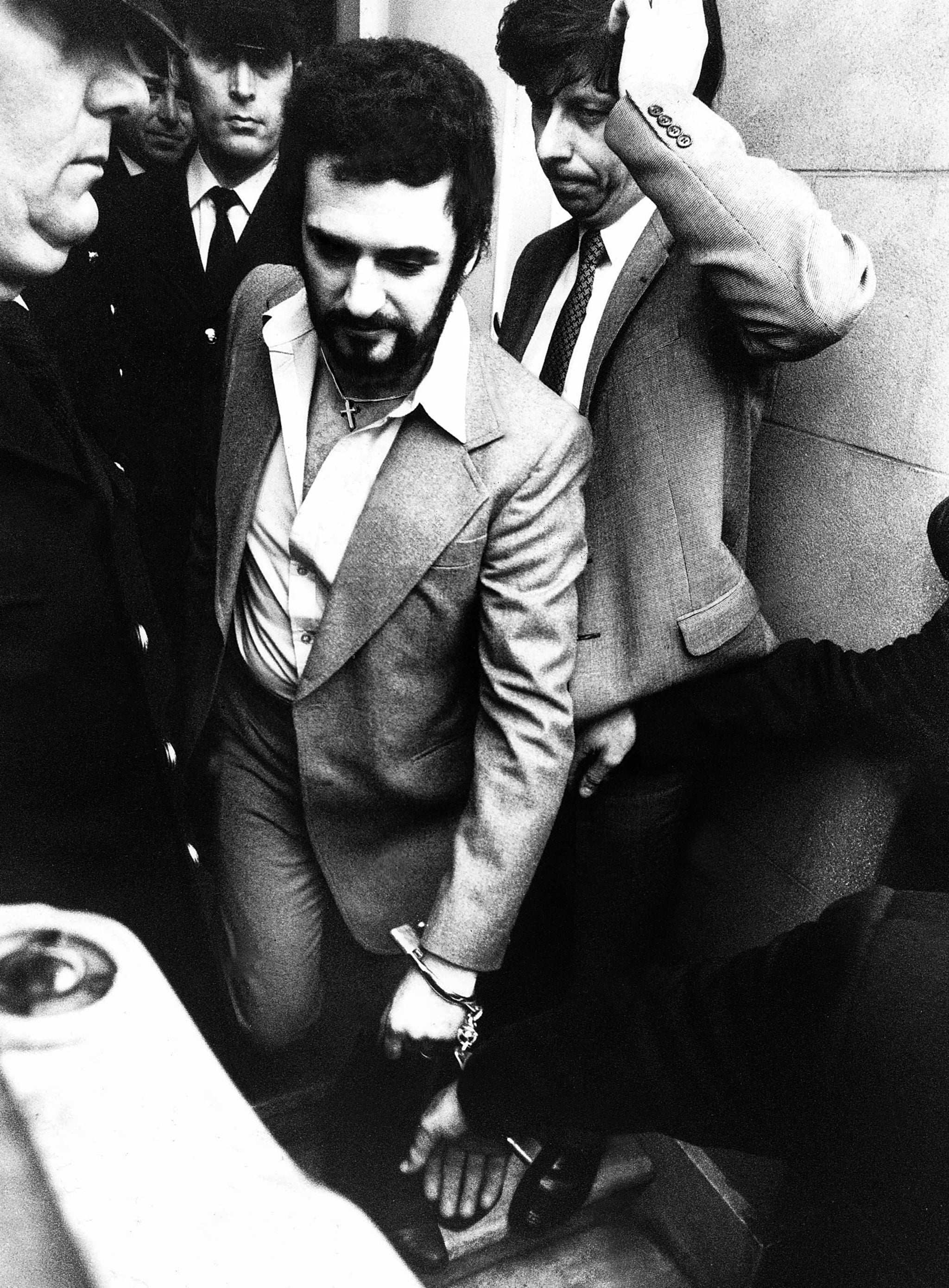 Peter Sutcliffe the Yorkshire ripper handcuffed leaving court msi January 5th 1981 A 35-year-old lorry driver from Bradford, suspected of carrying out 13 murders across West Yorkshire over the past five years, has appeared in court. Peter William Sutcliffe, of 6 Garden Lane, Bradford, is accused of murdering 20-year-old university student Jacqueline Hill, who was killed in Leeds seven weeks ago. (Photo by Stone Peter/Mirrorpix/Getty Images)