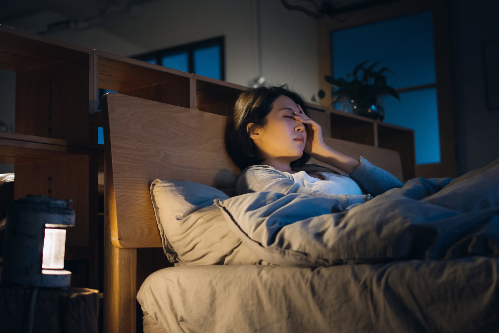 Young woman coughing at night