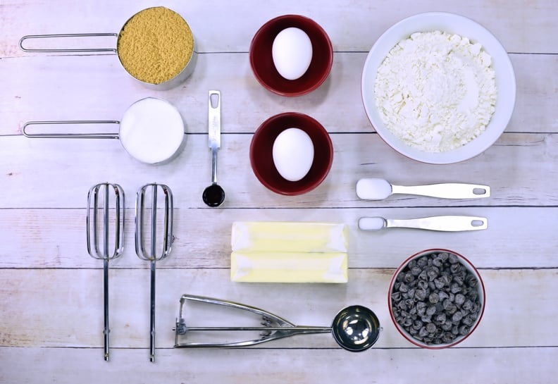 All of the ingredients to make chocolate chip cookies including sugar, flour, butter, eggs and chocolate chips