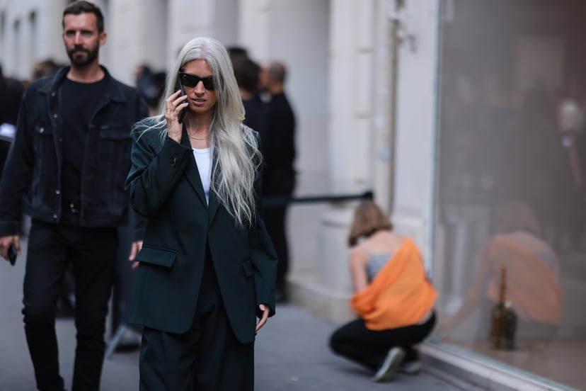 PARIS, FRANCE - JULY 06: A guest seen wearing black sunglasses from Ray-Ban, a gold necklace, a white ripped tank-top, black blazer jacket and a black suit pants, outside the Balenciaga show, during Paris Fashion Week - Haute Couture Fall Winter 2022 2023