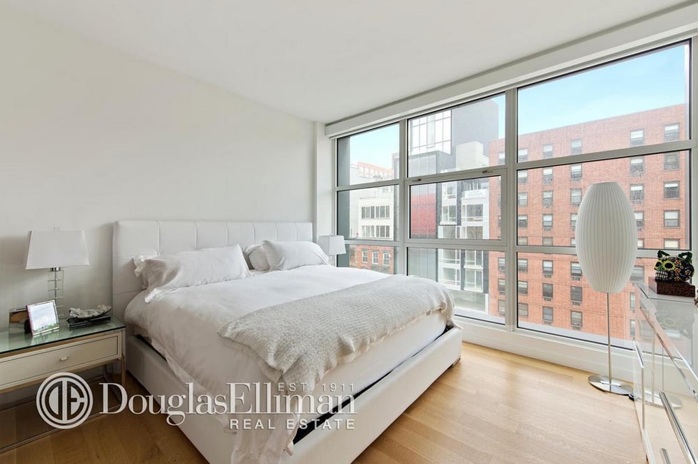 One of the apartment's two bedrooms is decorated in airy all-white.