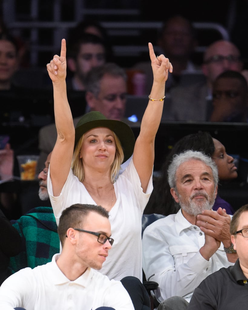 Kaley Cuoco put her fingers up while sitting courtside with her dad, Gary, at an LA Lakers game in January 2016.