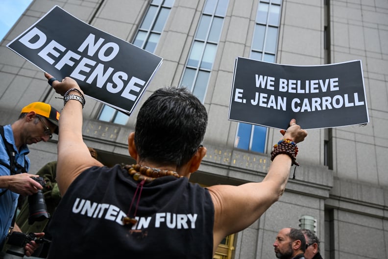 NEW YORK, NEW YORK - MAY 09: : A protester holds up signs outside a Manhattan Federal Court after a jury found former President Donald Trump liable for sexually abusing E. Jean Carroll in a Manhattan department store in the 1990's on May 09, 2023 in New Y