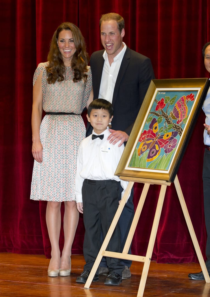 The couple posed proudly with a young artist during their visit to the Rainbow Center in Singapore. The stop was part of their Diamond Jubilee tour in September 2012.