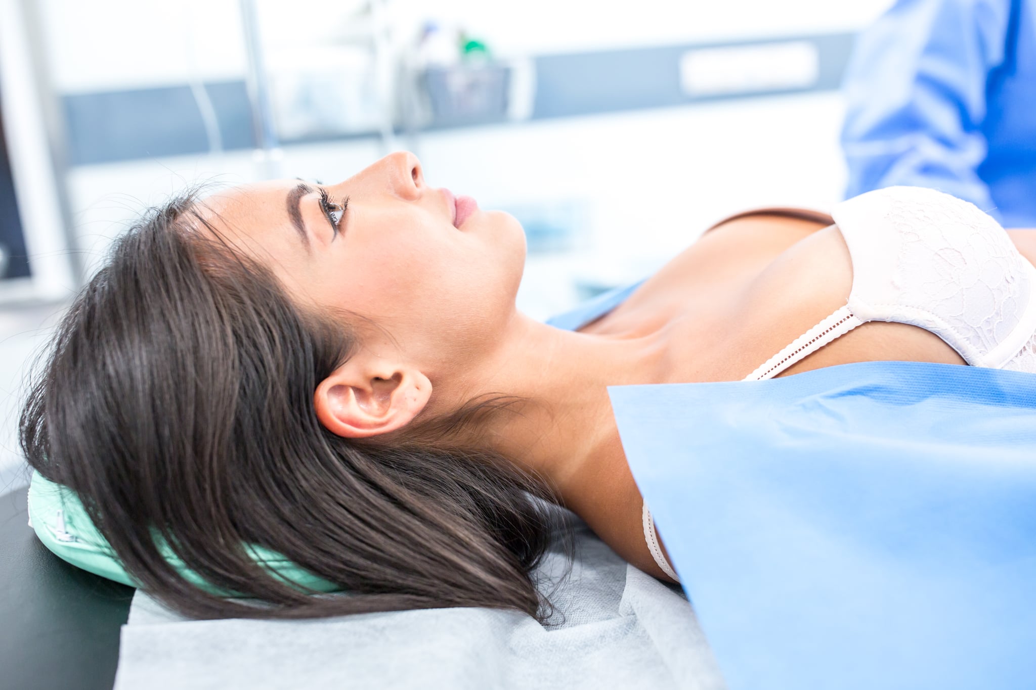 Woman in doctor's office discussing with surgeon breast implants.