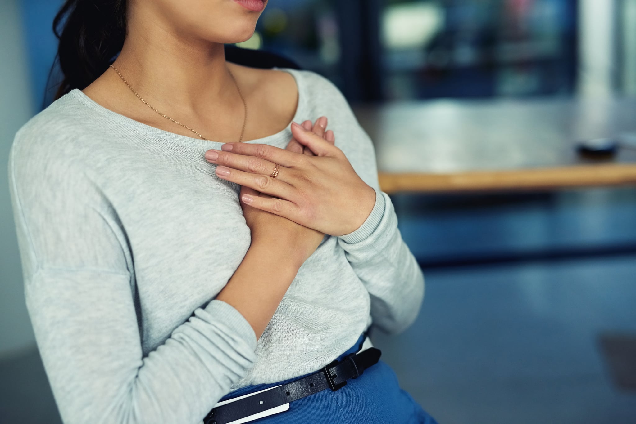 Closeup shot of an unidentifiable businesswoman holding her chest in pain