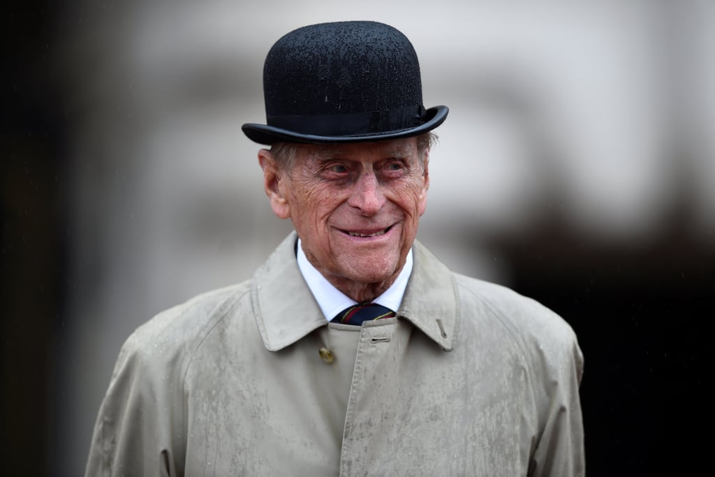 Prince Philip is officially on retirement time. The 96-year-old royal attended his last official public engagement when he took part in a parade to mark the finale of the 1664 Global Challenge, which raises funds and awareness for The Royal Marines Charity, at Buckingham Palace. Despite the pouring rain, Philip met with representatives from the organization, veterans, and cadets before receiving the 1664 Global Challenge baton and three cheers from the crowd. The event certainly holds special significance to the prince, who was appointed captain general in succession to Queen Elizabeth II's late father, King George VI, nearly 64 years ago.
Buckingham Palace announced Prince Philip's last duty in a statement in July, saying, "The Duke of Edinburgh will no longer undertake his own program of public engagements. The Captain General's Parade will bring His Royal Highness's individual program to a conclusion, although he may choose to attend certain events, alongside The Queen, from time to time." The royal first announced his decision to retire in May 2017 with full support from the queen. Over the past 70 years, Philip has carried out royal duties on behalf of over 780 organizations.