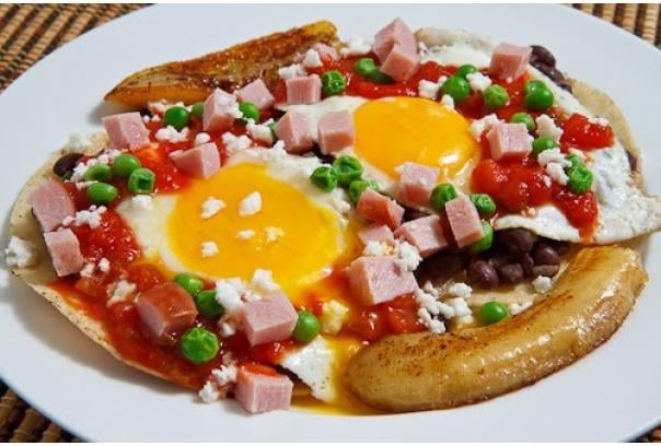 Break away from traditional Mexican huevos rancheros and try your hand at huevos motuleños, made up of fried eggs over refried black beans on a fried tortilla, topped with salsa, and served with fried plantains, chorizo, and crumbled queso fresco. What the what?!