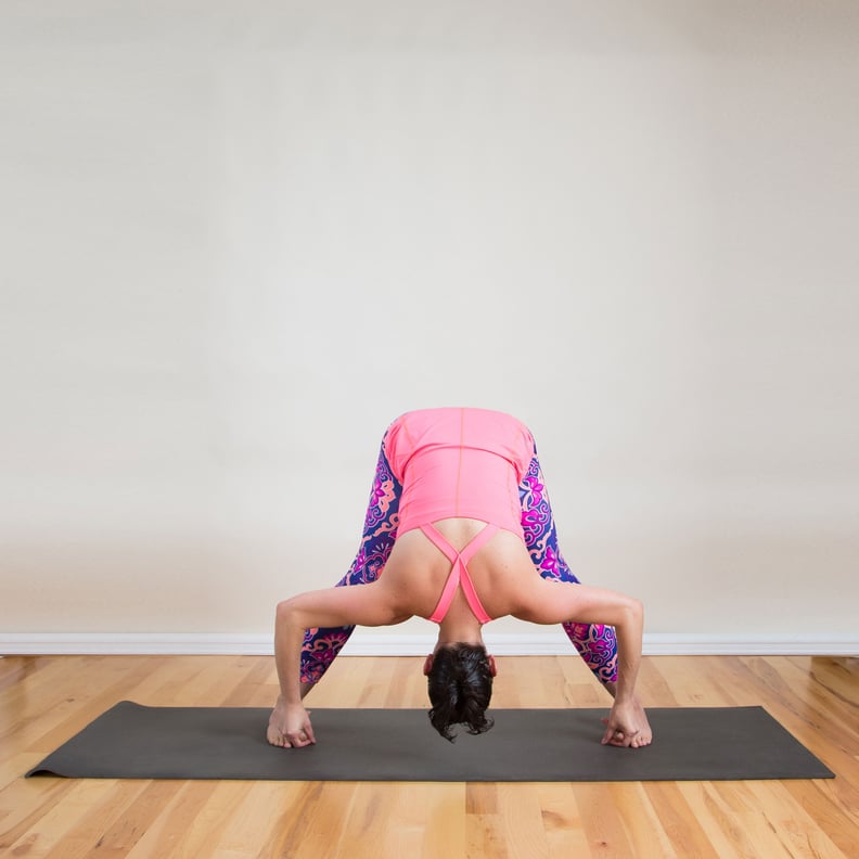 Woman doing intense Leg Stretch Pose D, Wide Legged Forward Fold