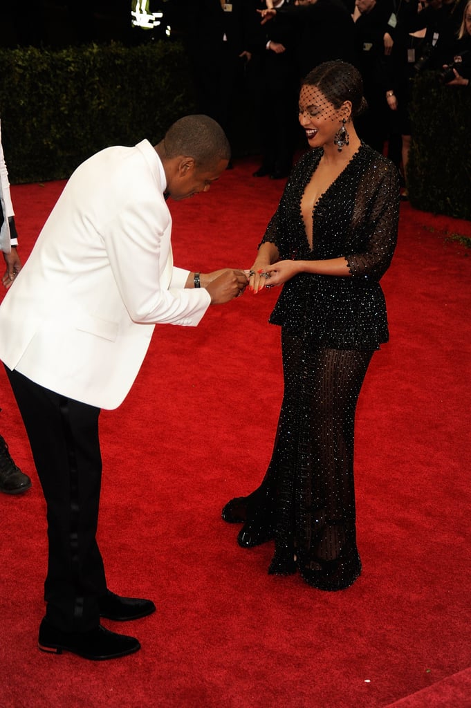 Jay Z placed Beyoncé's ring on her finger after it fell off on the Met Gala red carpet in May 2014.
