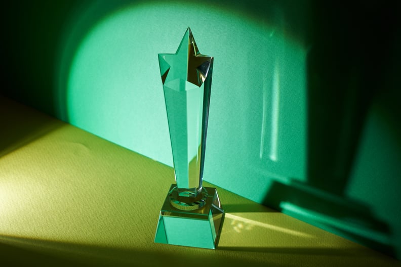 trophy crystal against green and yellow background