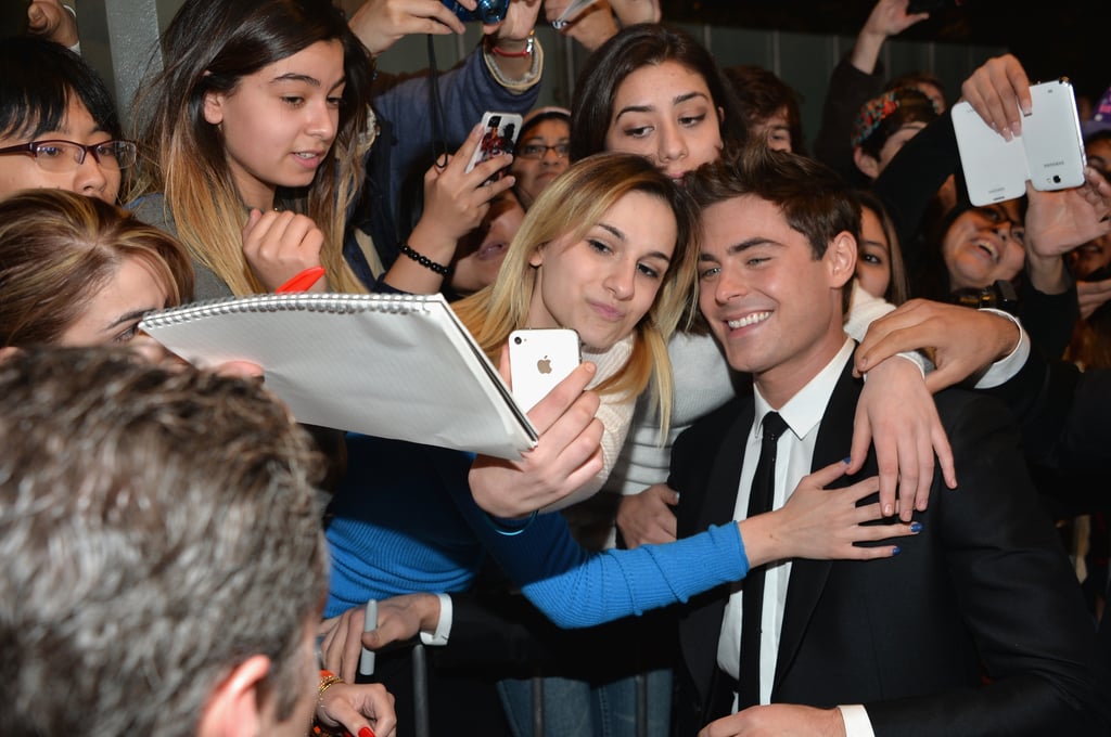 On Monday, Zac Efron took photos with a large group of female fans at the LA premiere of That Awkward Moment.