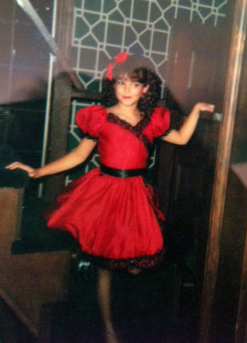 "My mom made me amazing Halloween costumes, most of them reflecting significant moments in fashion history: a poodle skirt, a flapper dress, and this can-can girl costume, which was probably my favorite. She altered an old red dress of hers to fit me, added lace and sequin trim, and layered it over a petticoat. My favorite part of the costume was the fishnet stockings. My favorite thing about this photo is my pose."
— Nancy Einhart, VP and executive editor
