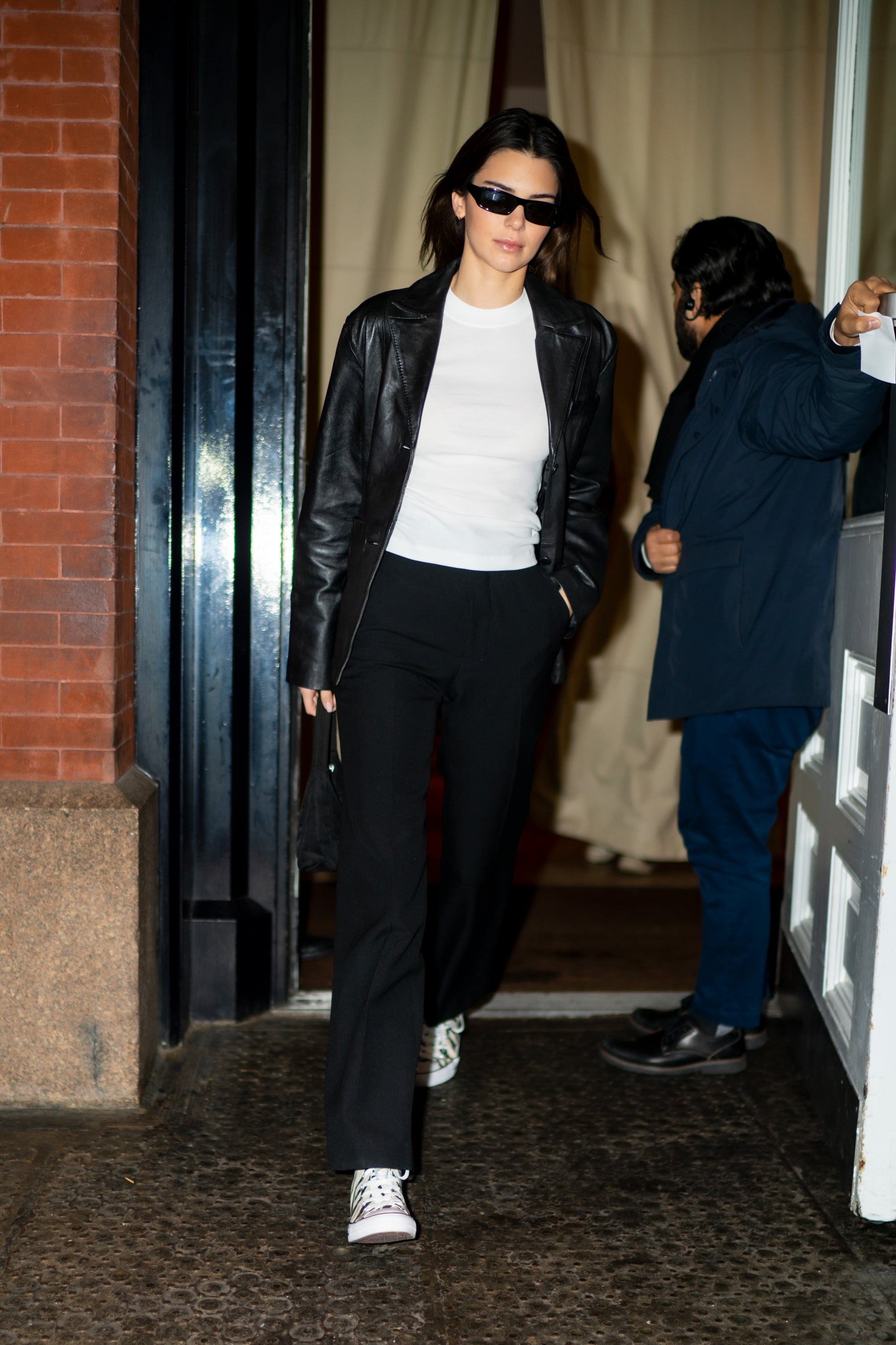 Kendall JennerOutfit Look in White Pants Street Style 2019 Oversized Solid  Beige Cotton Trousers Oversized White Graphic Tee Round White Adidas  Crisscross Tie   Kendall jenner outfits casual Kendall jenner street