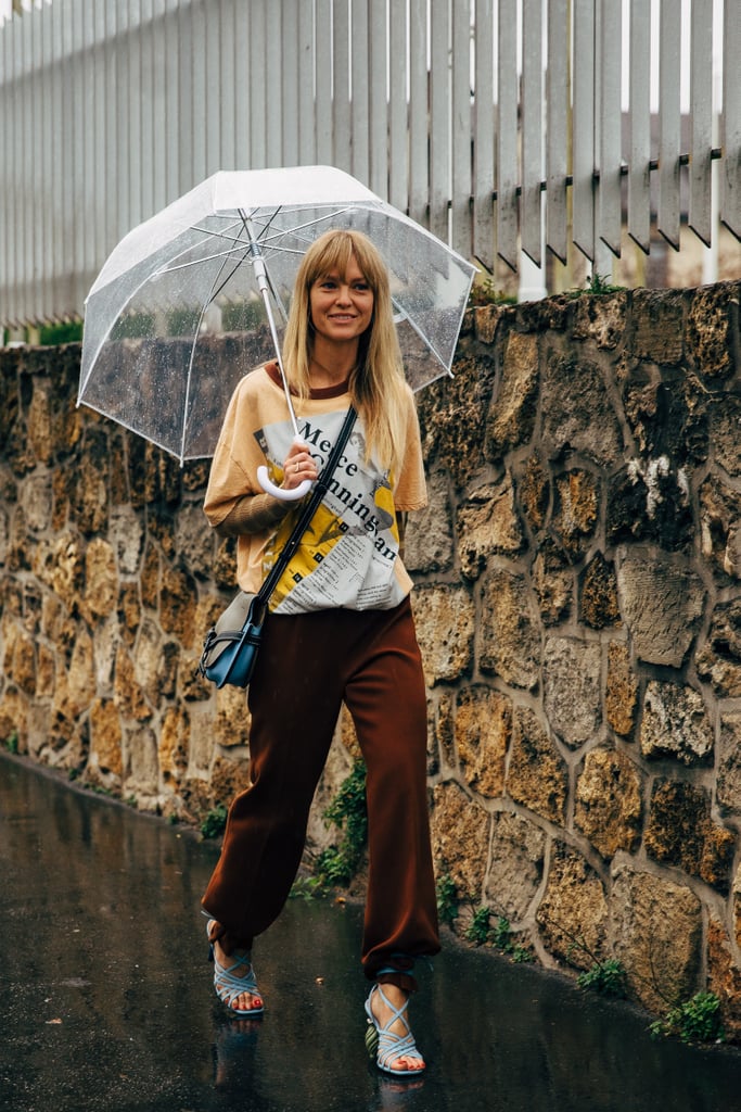 Style a blue pair of strappy sandals with a baggy tee and brown pants.