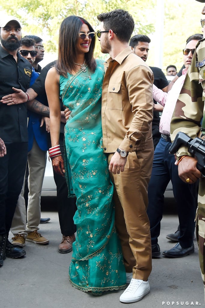 For her first outing as a married couple, Priyanka wore a green sari with cat-eye sunglasses. Nick styled his khaki set with Westward Leaning sunglasses,