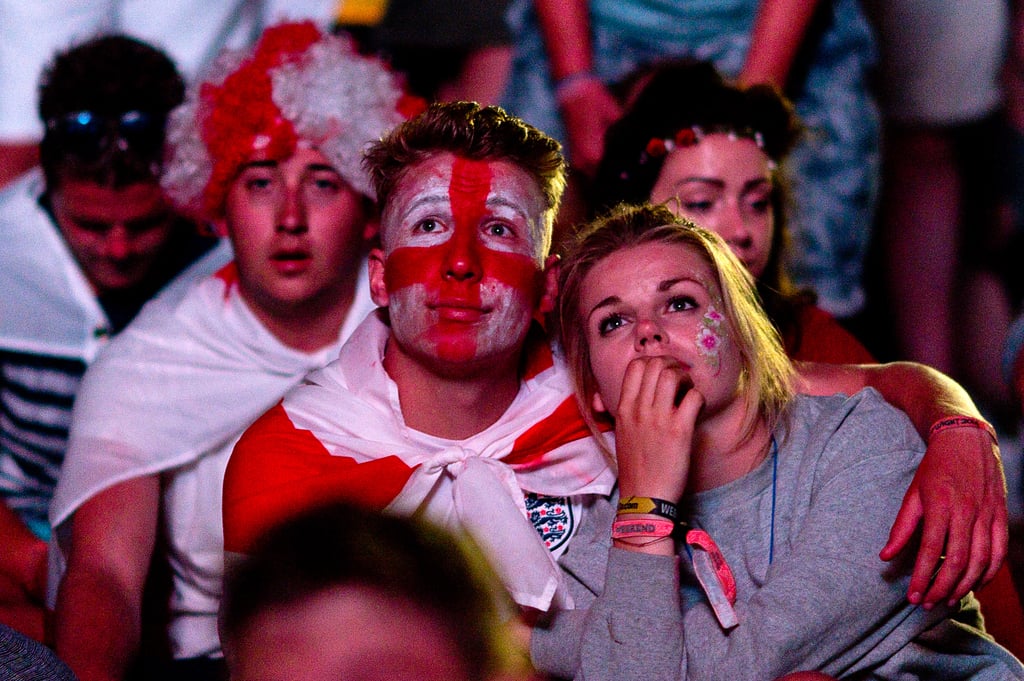 Fans watched the game between England and Italy at a park in Newport, England.