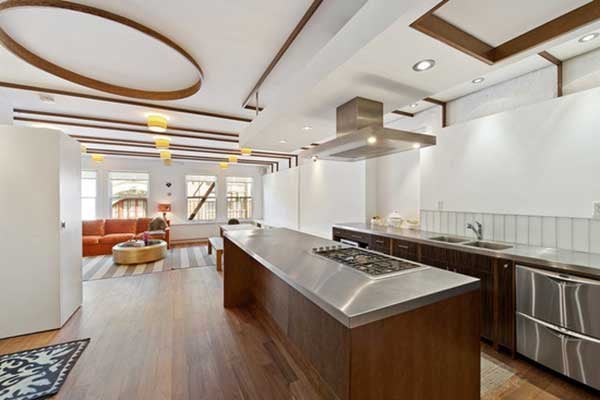 Walnut floors and oversized windows complement exquisite architectural details, and a stainless steel gourmet kitchen is perfect for any amateur chef.