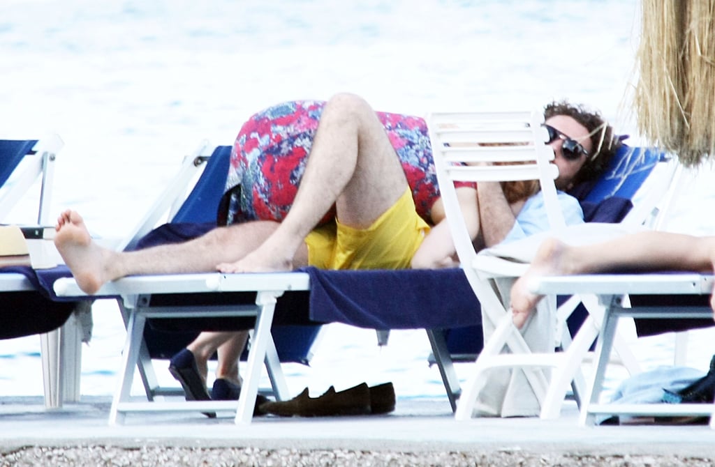 Jessica snuggled with her boyfriend while he was resting on a chaise.