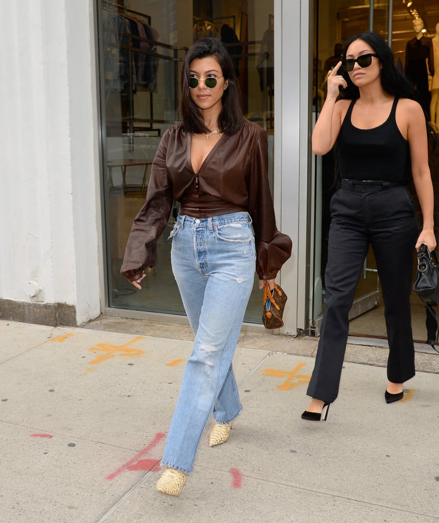 She paired it with a brown blouse, straight-leg jeans, and snake-print boots while shopping in Soho in June 2018.