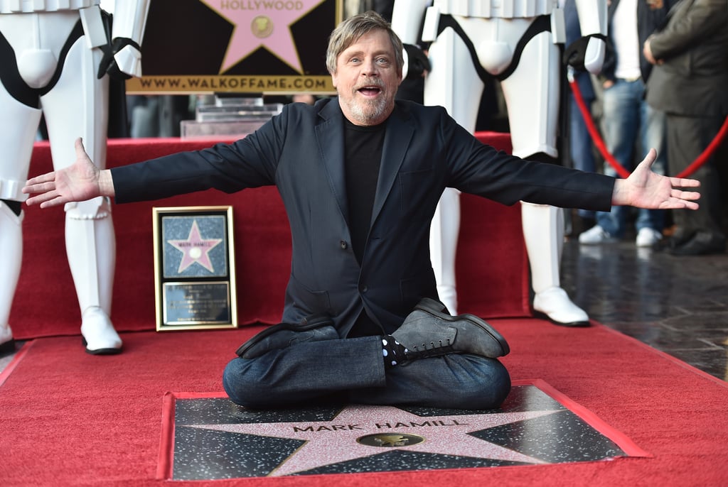 Mark Hamill brought back the enthusiasm of a young Luke Skywalker on Thursday, hereby known as "Jedi Day," when he was honored with his well-earned star on the Hollywood Walk of Fame. 
Both Star Wars creator George Lucas and costar Harrison Ford were on hand to sing Mark's praises at the event, with Harrison quipping: "wow, there was a lot more people that showed up for my star." Harrison continued his speech noting the absence of "the other member of our trio" Carrie Fischer, adding "but I feel her presence." Luckily, Carrie's daughter Billie Lourd was there represent Leia's legacy, along with Star Wars newbie Kelly Marie Tran, R2-D2, and a smattering of stormtroopers. Read on to see all the best photos from the celebration.