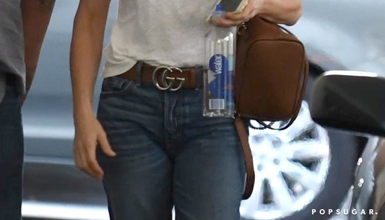 Jennifer Aniston in a white button-down shirt, bootcut jeans and a Gucci  belt - click through for more c…