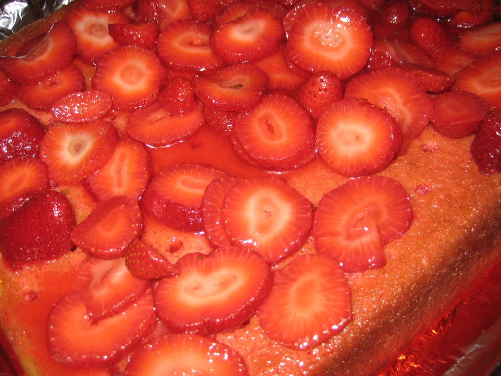 Evenly spread the strawberries over the cake. 