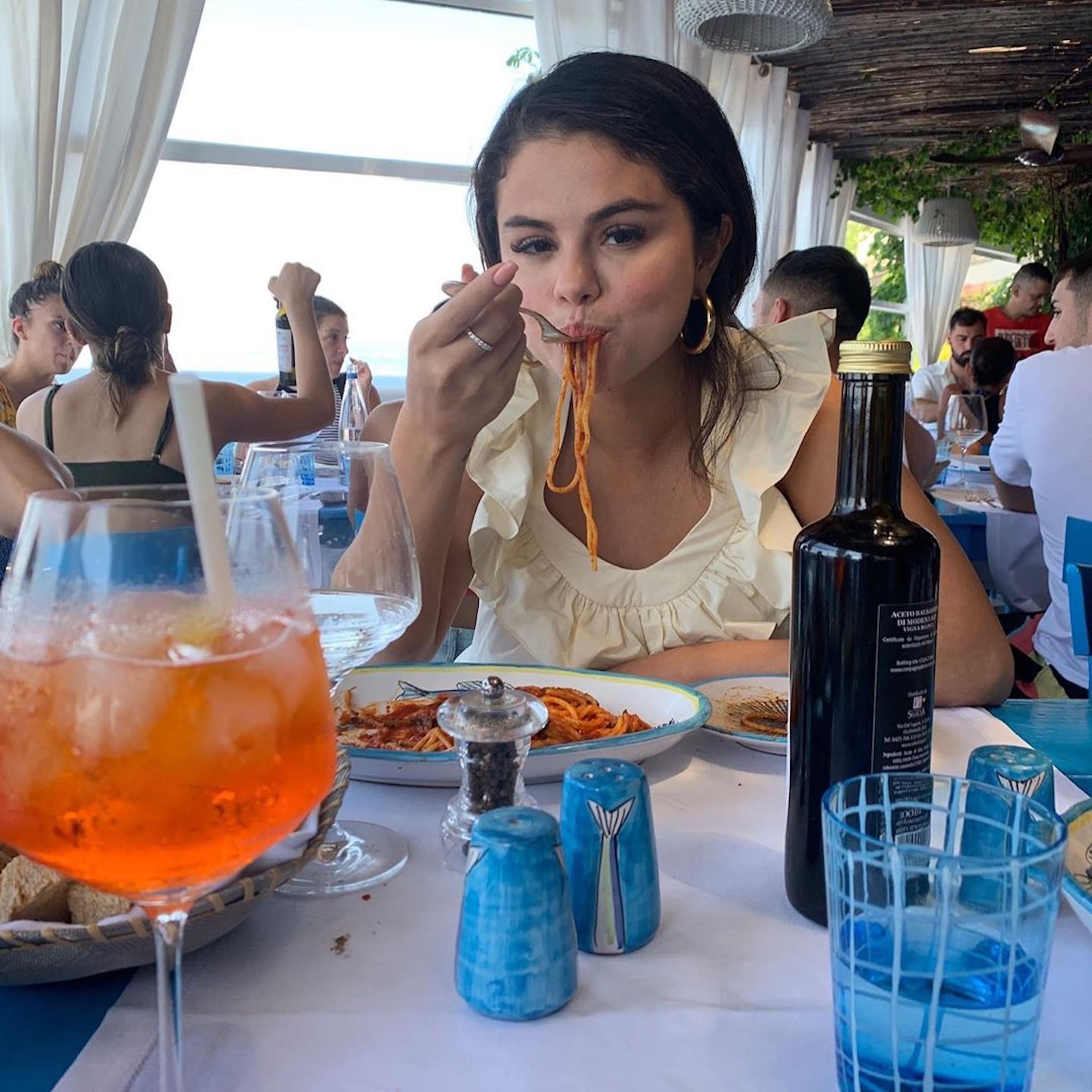 Selena Gomez Wears a Cute White Maxi Dress and Straw Hat in Italy