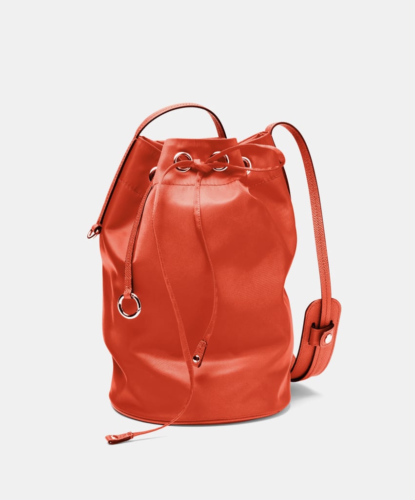 Danimás The Punch Bag ($395)
This abstract purse, inspired by a punching bag, adds a whimiscal side to your athletic aesthetic. Simply place all your go-to items inside the large center compartment and cinch it closed with the leather drawstring. 
Pros: You'll find a dedicated phone pocket to help you stay organized
Cons: This design strays away from the traditional wide gym bag blueprint, offering a more narrow storage solution
Material: Nylon
Dimensions: 12" H x 7" D
Colorways: Four
Who It's Best For: The laid-back girl on the go who needs a quick and easy catchall bag